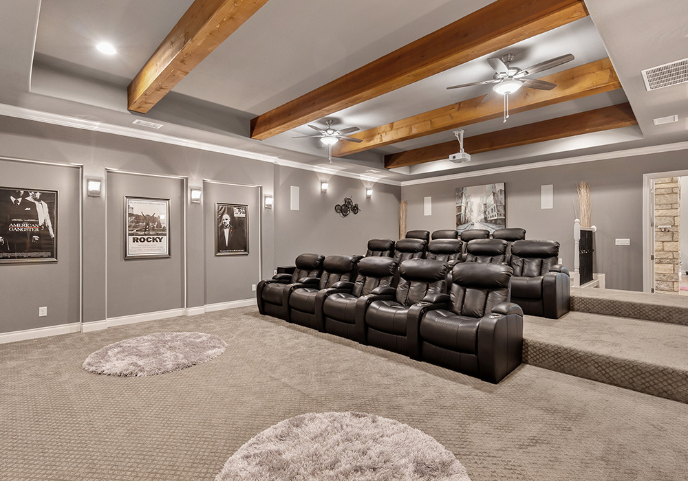 Upscale custom media room with movie theatre chairs